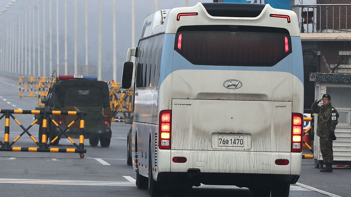 A bus carrying a delegation of South Korean officials passes a military check point on the road leading to the border truce village of Panmunjom in Paju on 15 January, 2018. Photo: AFP