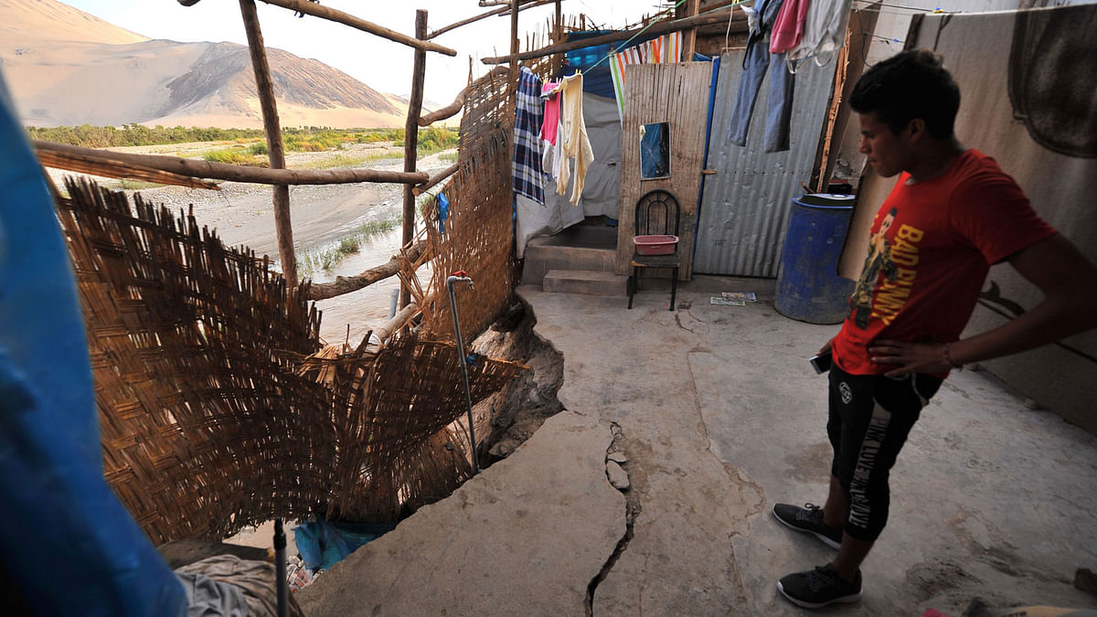 Gonzalo Huamani looks at earthquake damage to his home next to the Acari River in the town of Acari, Arequipa province in southern Peru. Photo: AFP