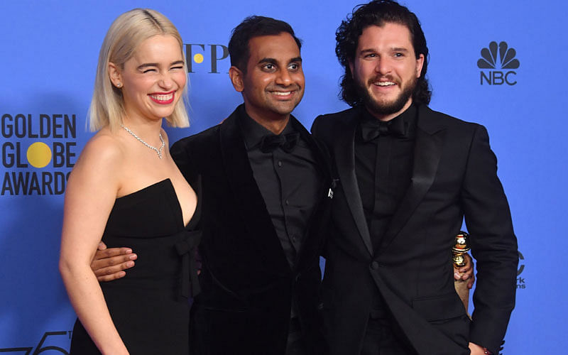 Actors Emilia Clarke (L) and Kit Harington (R) pose with comedian Aziz Ansari and his award for Best Performance by an Actor in a Television Series Musical or Comed during the 75th Golden Globe Awards on 7 January 2018, in Beverly Hills, California. AFP