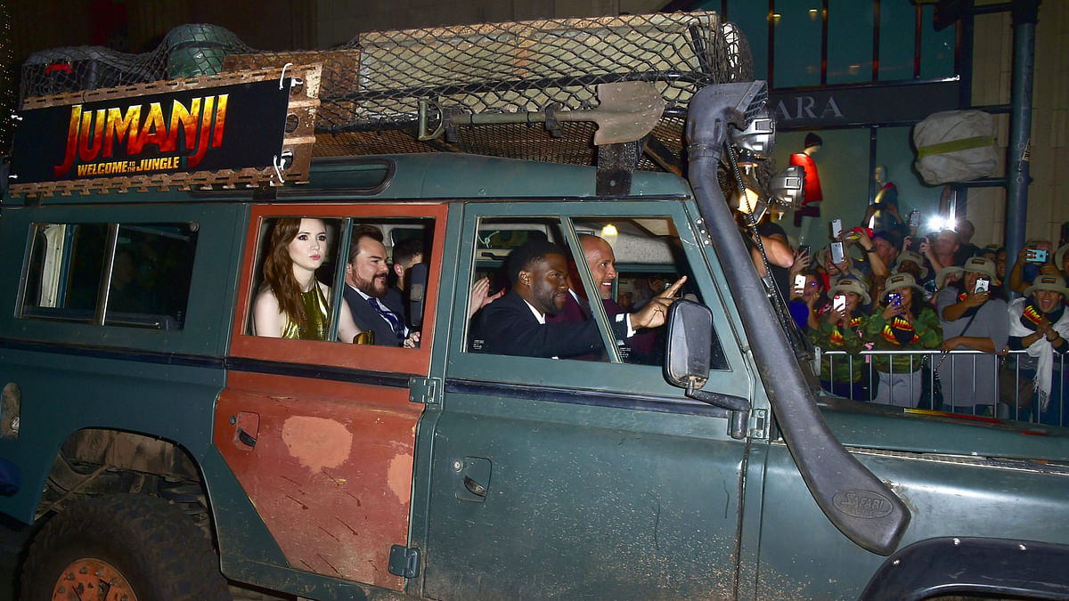This file photo taken on 11 December, 2017 shows members of the cast, including in front seat, Kevin Hart and Dwayne Johnson and in rear, Karen Gillan and Jack Black, arrive in a vehicle for the premiere of the film `Jumanji: Welcome to the Jungle` in Hollywood, California. Photo: AFP