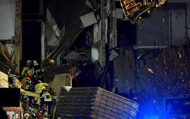 Firefighters inspect a collapsed building, at the Paardenmarkt in Antwerp on 15 January 2018, after several buildings collapsed following an explosion. Photo: AFP