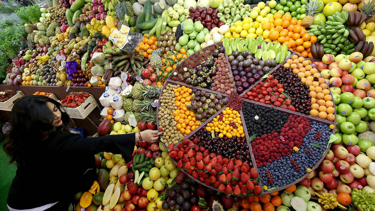 Ghadir Srour, executive manager of Star Fruit, arranges a stall of fruits displayed during the Horeca hospitality exhibition in Kuwait City on 16 January. Photo: AFP