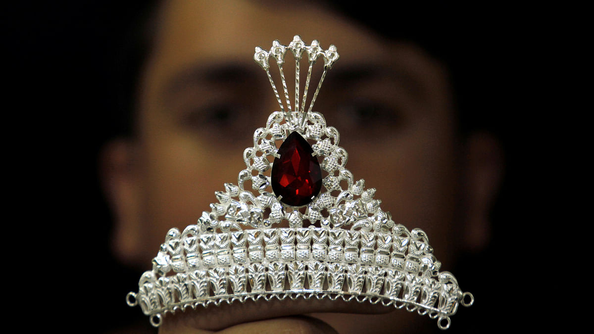 A salesman shows a tiara at a jewellery shop in the market in Peshawar, Pakistan on 17 January 2018. Photo: Reuters