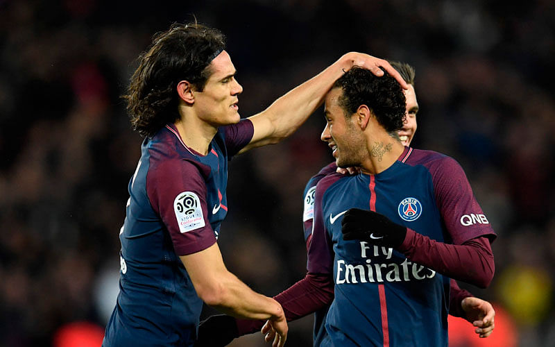 Paris Saint-Germain’s Brazilian forward Neymar ® celebrates with Paris Saint-Germain’s Uruguayan forward Edinson Cavani after scoring a free-kick during the French L1 football match between Paris Saint-German and Dijon on 17 January 2018 at the Parc des Princes stadium in Paris. Photo: AFP