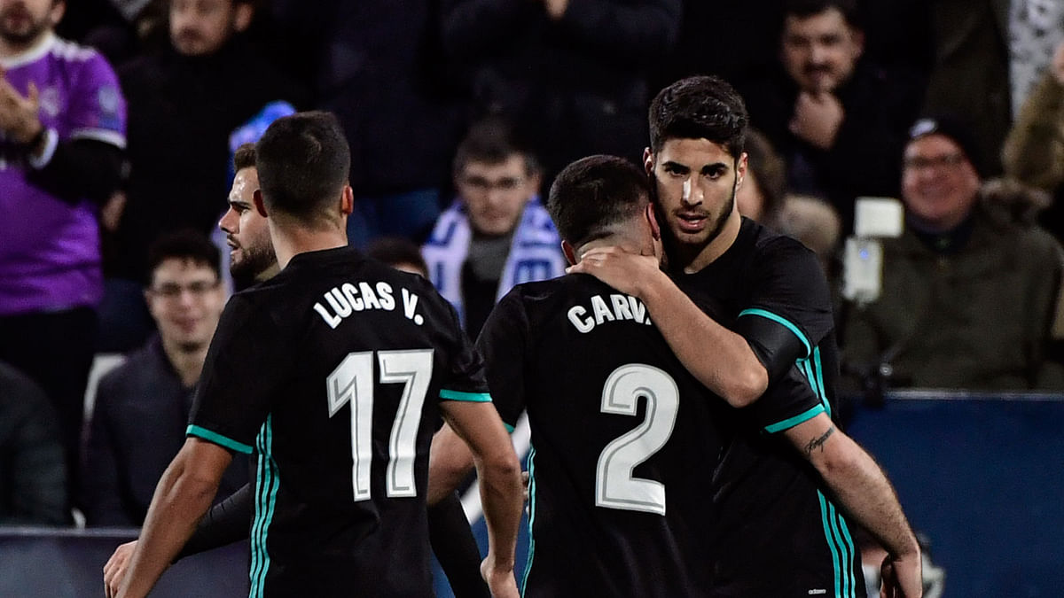 Real Madrid`s Spanish midfielder Marco Asensio (R) celebrates with teammates after scoring a goal during the Spanish `Copa del Rey` (King`s cup) football match between Leganes and Real Madrid at the Estadio Municipal Butarque in Leganes on 18 January 2018. AFP