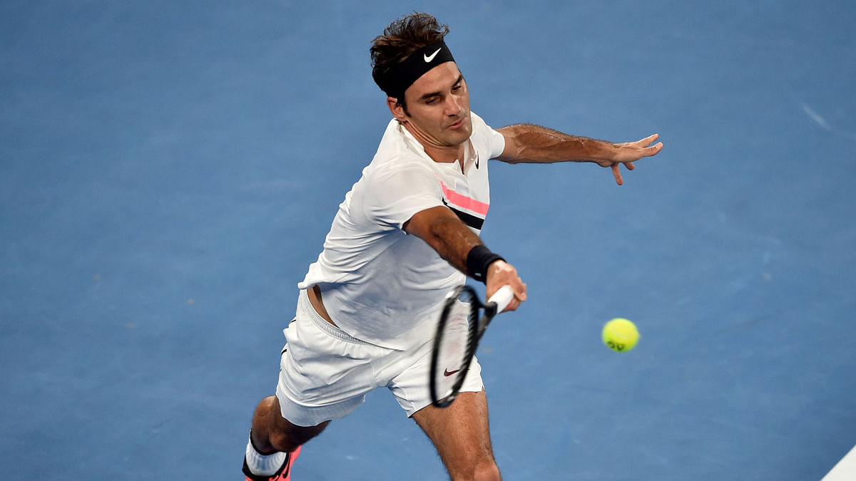 Switzerland`s Roger Federer plays a forehand return to Germany`s Jan-Lennard Struff during their men`s singles second round match on day four of the Australian Open tennis tournament in Melbourne on 18 January 2018. AFP