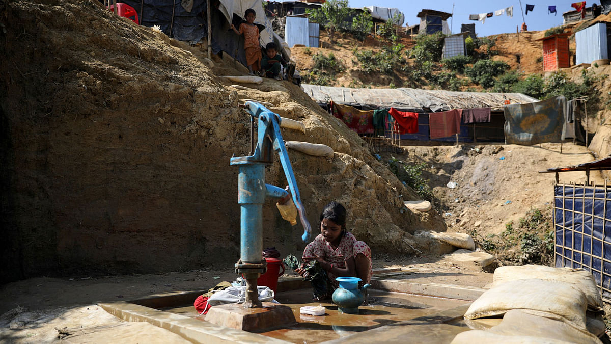 A Rohingya girl washes clothes with tube-well water at Balukhali refugee camp in Cox`s Bazar, Bangladesh, on 20 January 2018. Reuters