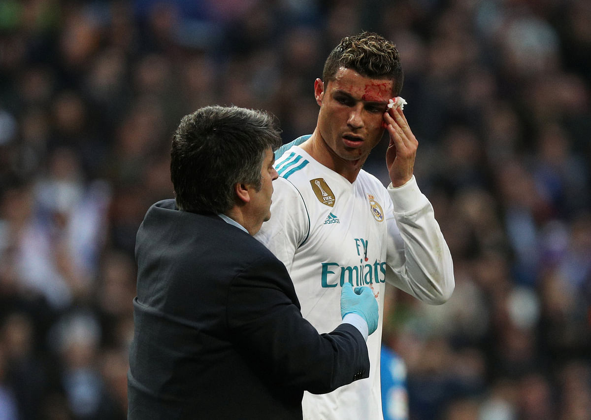 Real Madrid’s Cristiano Ronaldo receives treatment after sustaining an injury whilst scoring their sixth goal. REUTERS