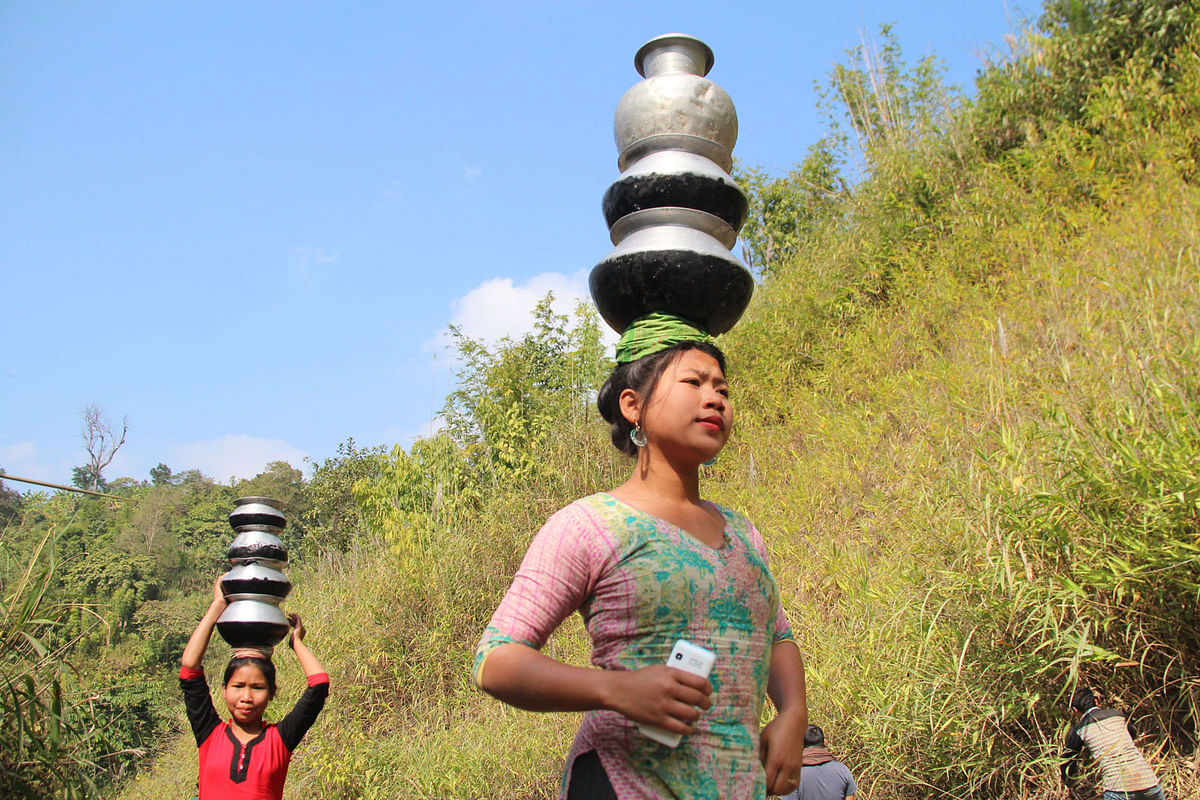 Girls carry water home from springs and wells in the remote Sajek Valley of Rangamati. Photo: Nirab Chowdhury