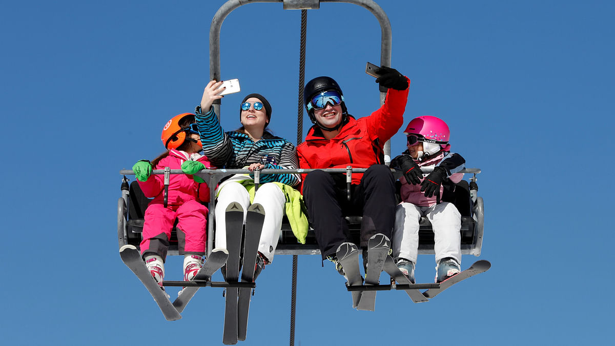 A couple takes selfies as they ride a ski lift at the Mzaar Ski Resort in Kfardebian, Lebanon 20 January. Photo: Reuters