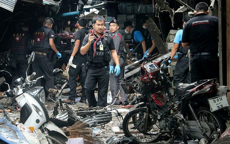 A Thai forensics unit scours the aftermath of a motorcycle bombing which killed three civilians and wounded others at a market in the restive southern Thai province of Yala on 22 January, 2018. Photo: AFP