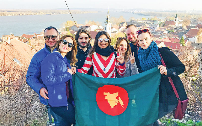 Holding the Bangladesh flag with tourists in Serbia