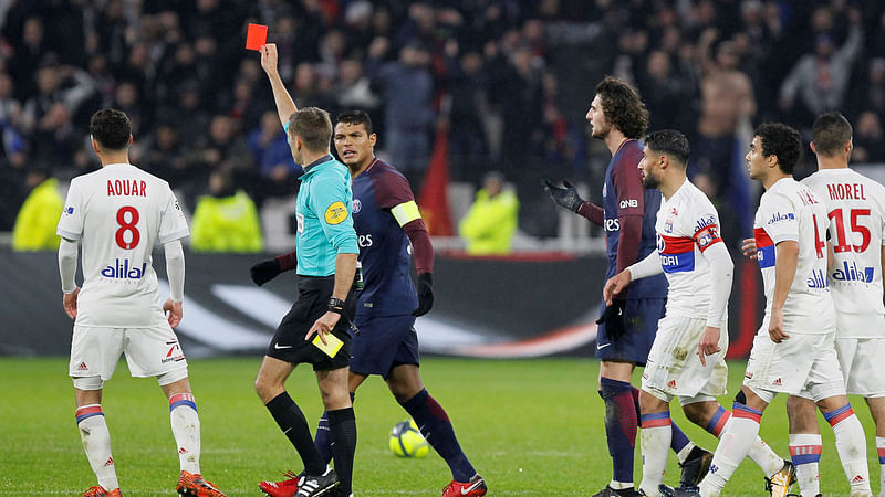 Paris Saint-Germain’s Thiago Silva speaks with referee Clement Turpin after Paris Saint-Germain’s Dani Alves is sent off in Olympique Lyonnais vs Paris St Germain match at Groupama Stadium, Lyon, France on Sunday. Photo: AFP