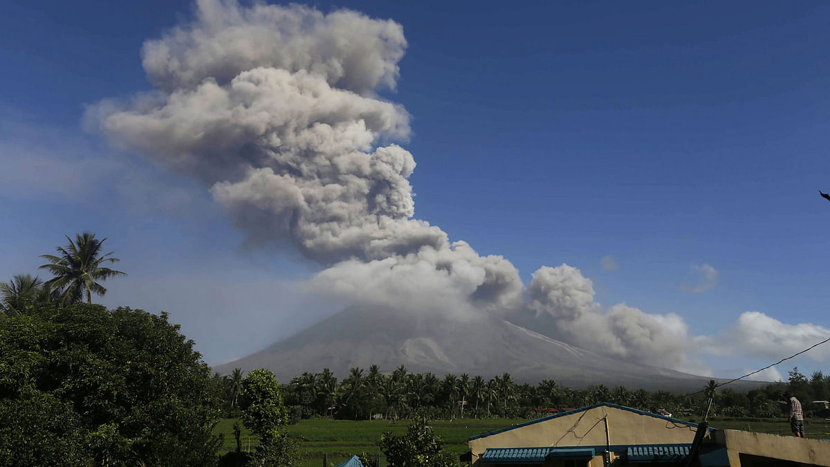 Ash spews from the Mayon volcano as it continues to erupt, seen from the town of Daraga in Albay province, south of Manila on Tuesday. Photo: AFP