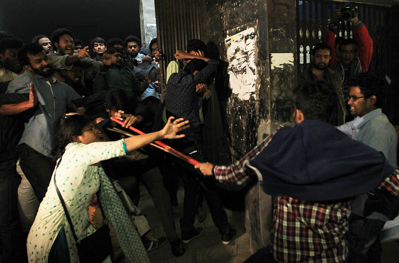 A female student tries to defend herself when BCL activists attack demonstrators in front of the VC`s office on Tuesday. Photo: Sajid Hossain