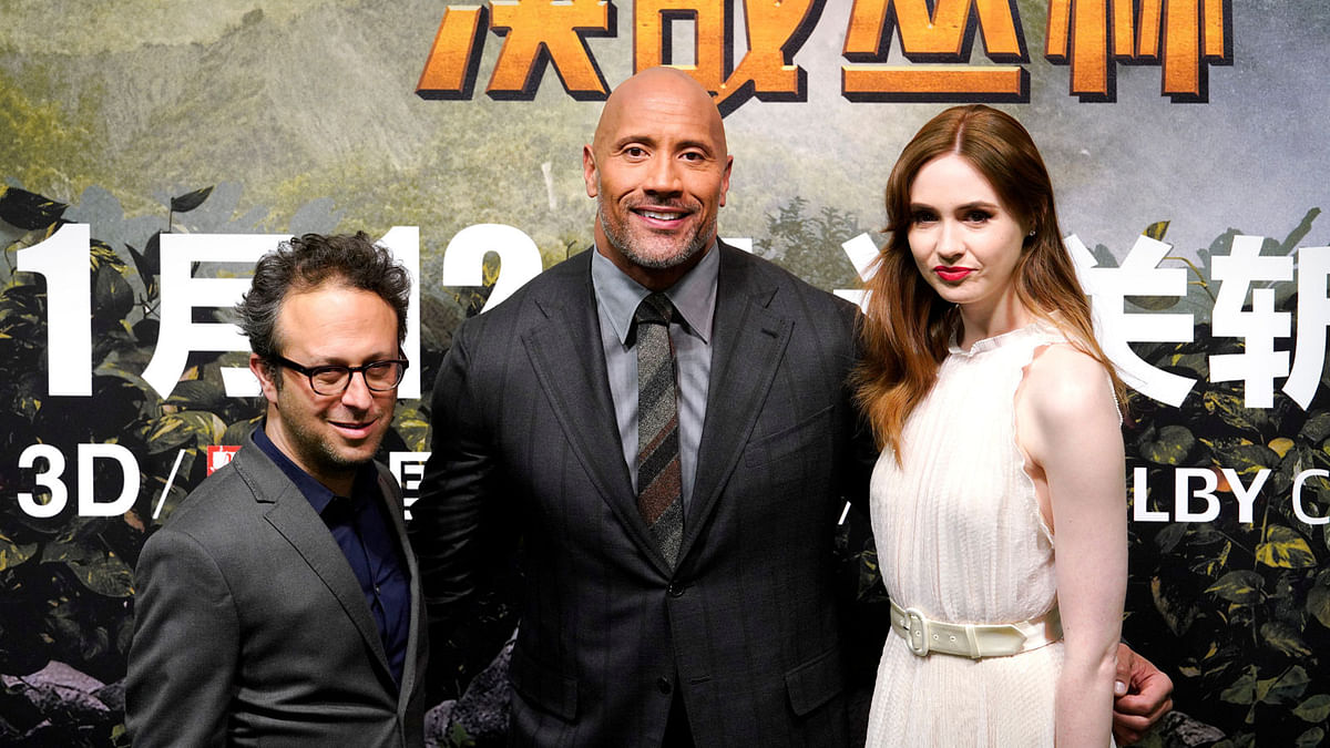 Director Jake Kasdan (L), cast members Dwayne Johnson (C)and Karen Gillan attend a news conference promoting their film `Jumanji: Welcome to the Jungle` in Beijing, China on 4 January. Photo: Reuters