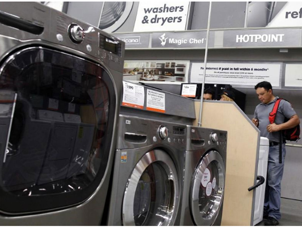 Shoppers look at washers and dryers at a Home Depot store in New York, on 29 July 2010. -- Reuters