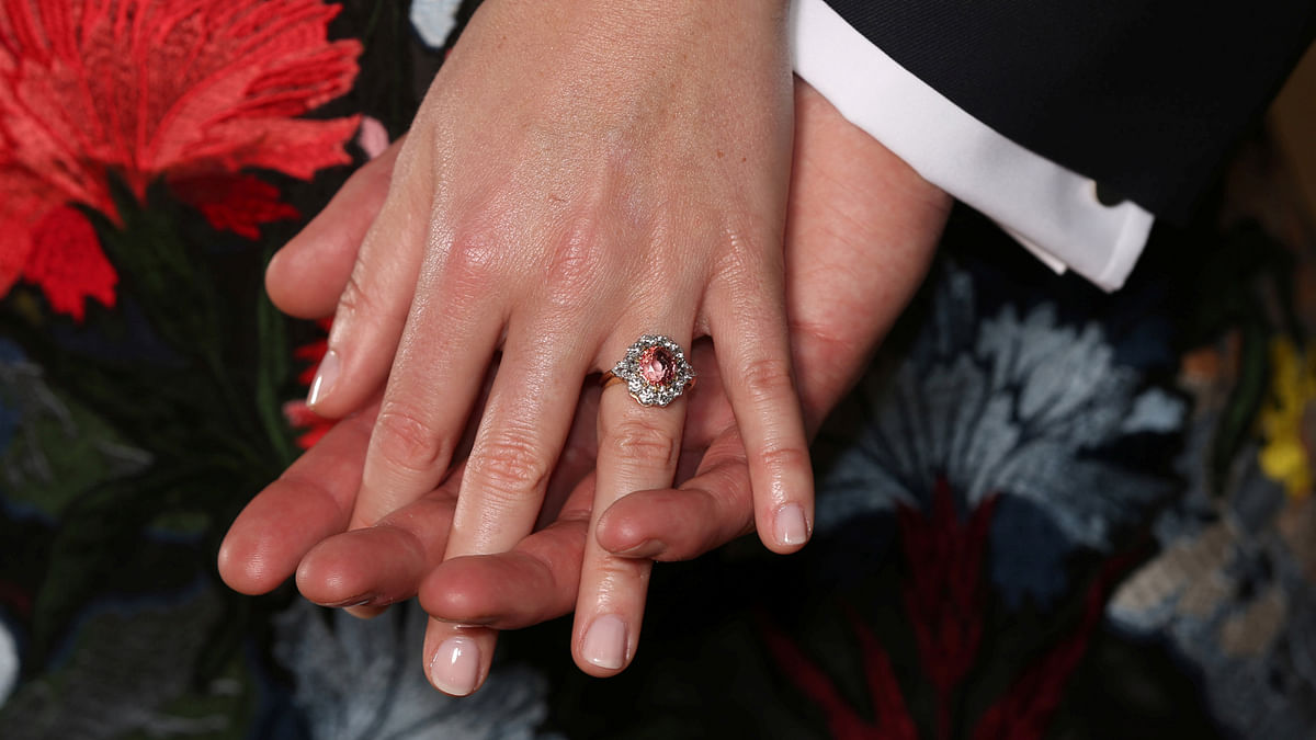 Britain`sPrincess Eugenie wears a ring containing a padparadscha sapphire surrounded by diamonds as she and Jack Brooksbank pose in the Picture Gallery after they announced their engagement, at Buckingham Palace, London on 22 January 2018. Photo: Reuters