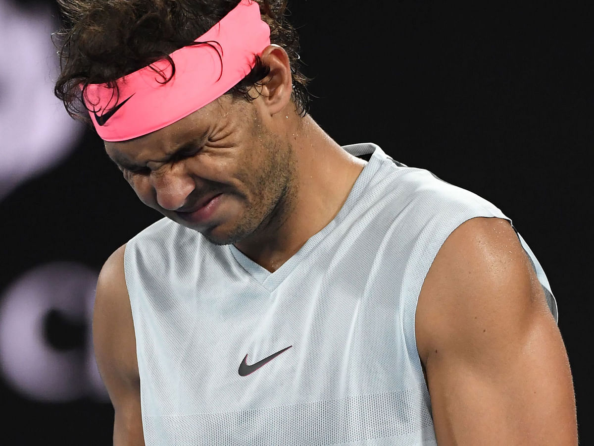 Spain`s Rafael Nadal grimaces as he walks on court while preparing to serve to Croatia`s Marin Cilic during their men`s singles quarter-finals match on day nine of the Australian Open tennis tournament in Melbourne on 23 January, 2018. Photo: AFP