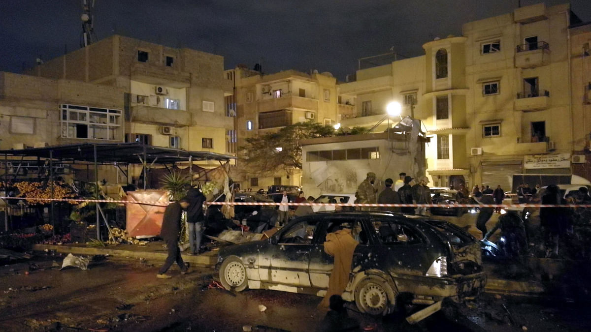 People gather at the site of twin car bombs in Benghazi, Libya. Photo: Reuters
