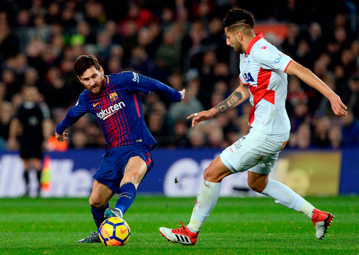 Barcelona’s Argentinian forward Lionel Messi (L) vies with Alaves’ Chilean defender Guillermo Maripan during the Spanish league football match between FC Barcelona and Deportivo Alaves at the Camp Nou stadium in Barcelona on Sunday. Photo: AFP