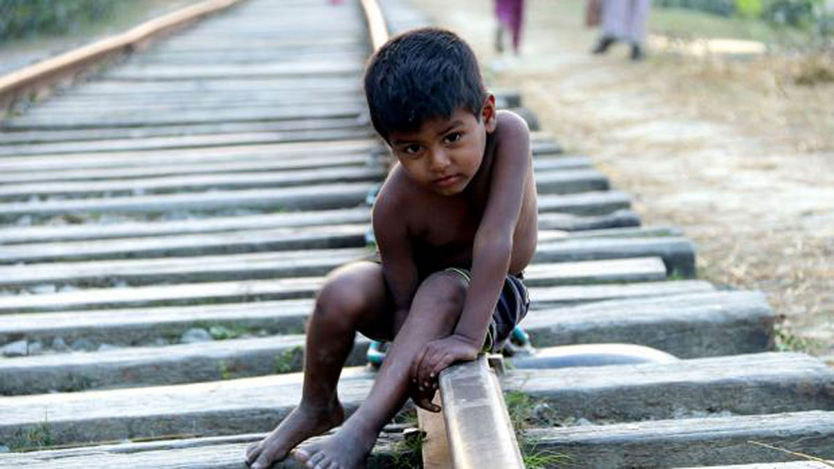 A child sits on the railway tracks at Sharsha, Jessore on 28 January. Despite the risks, people often sit and cross the tracks. Photo: Ehsan-Ud-Daula