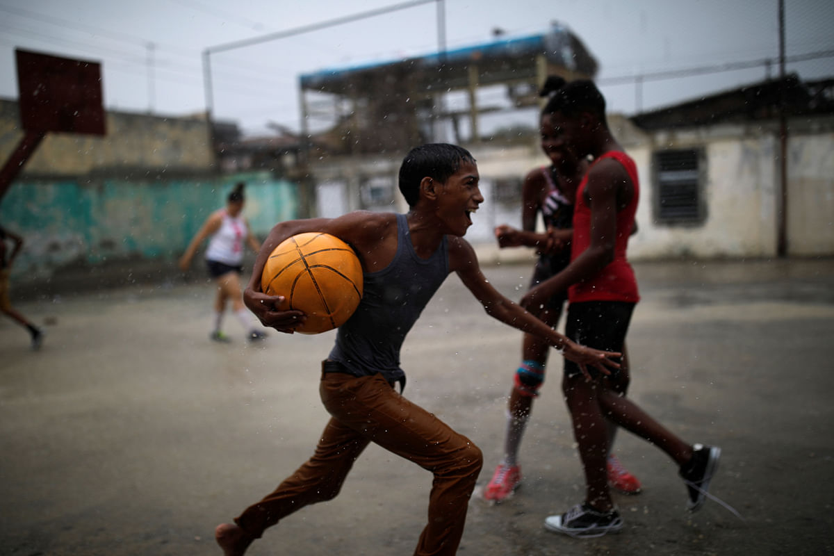 A boy runs with a ball during a soccer game in the city of Guantanamo, Cuba, on 6 December 2017. Photo: Reuters
