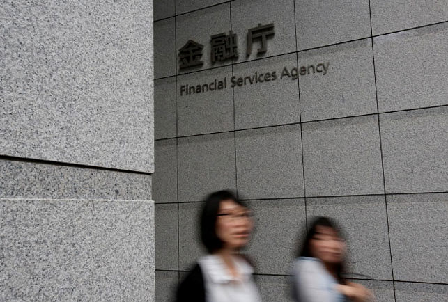Women walk under a sign of Japan`s Financial Services Agency in Tokyo, Japan on June 2017. -- Reuters