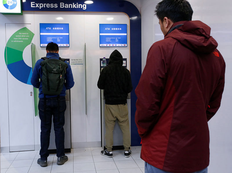 People use ATM machines at a bank in Hong Kong, China on 29 January 2018. Reuters