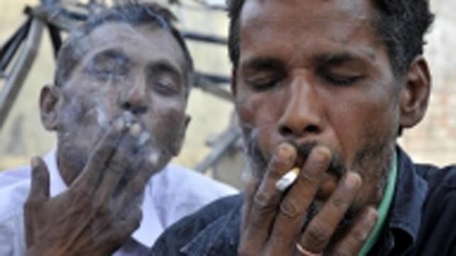 Two men are smoking. Photo: IANS