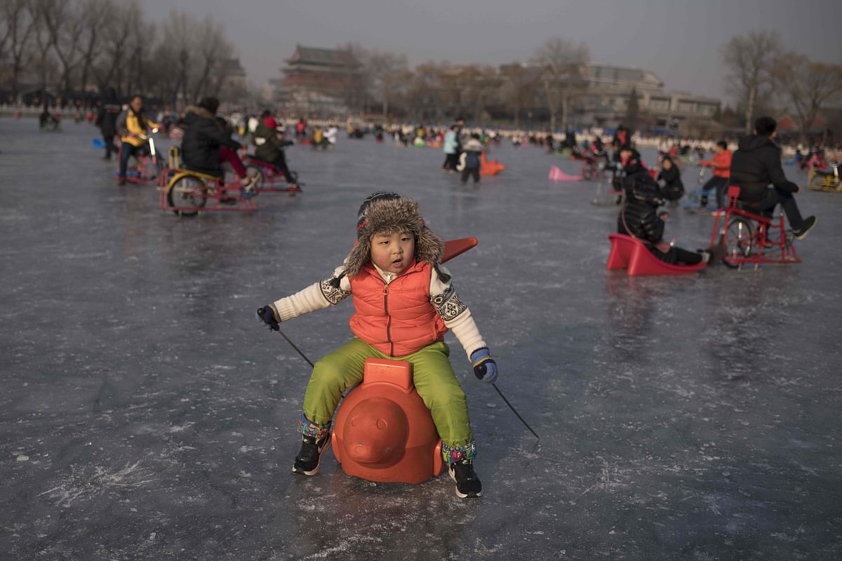 A baby enjoys riding on the ice of the frozen Hou Hai lake in Beijing ahead of the Lunar New Year in China on 6 February. . China will mark the beginning of the Lunar New Year on February 16. Photo: AFP