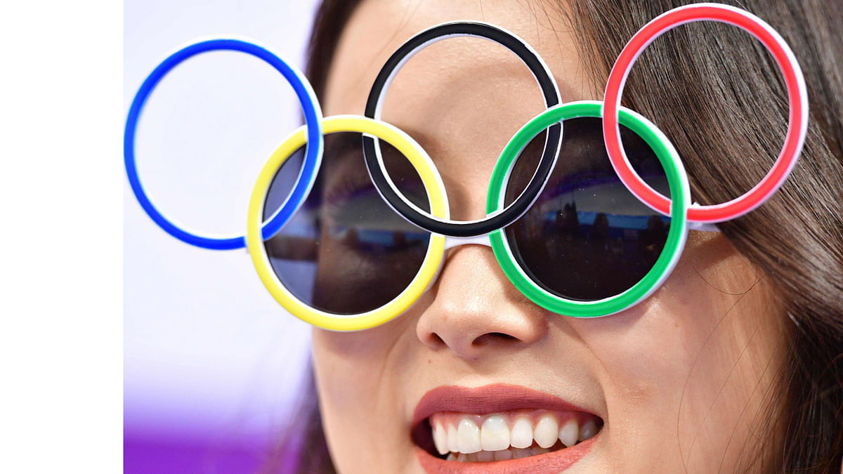 A woman wears Olympic rings sunglasses during the figure skating team event men`s single skating short program during the Pyeongchang 2018 Winter Olympic Games at the Gangneung Ice Arena in Gangneung on February 9, 2018. AFP