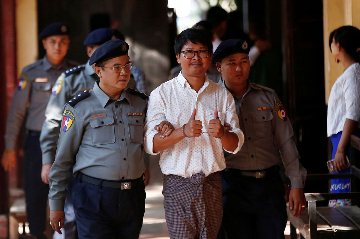 Detained Reuters journalist Wa Lone escorted by police, arrives for a court hearing in Yangon. Reuters