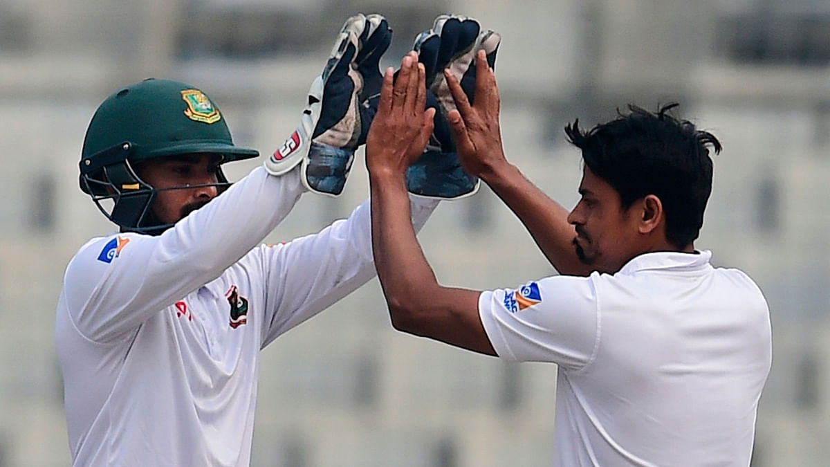 Bangladesh`s Taijul Islam (R) celebrates with teammate Liton Das (L) after the dismissal of Sri Lankan batsman Rangana Herath during the third day of the second cricket Test at the Sher-e-Bangla national cricket stadium in Dhaka on 10 February 2018. AFP