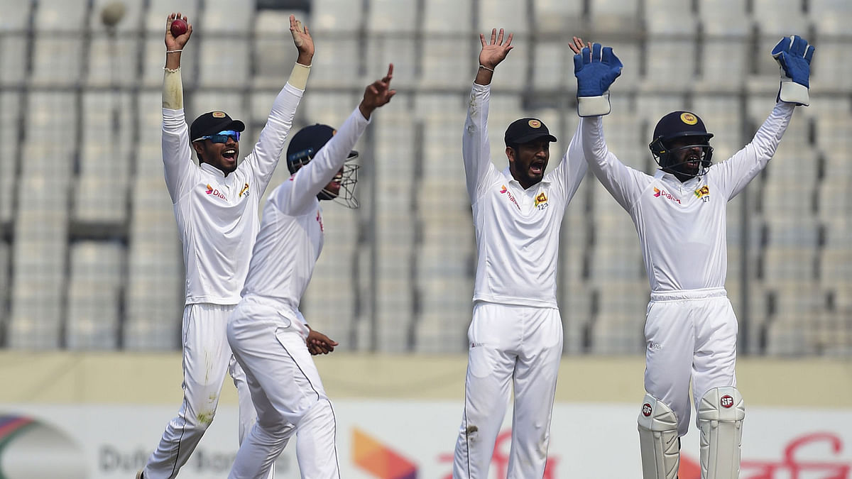 Sri Lanka wicketkeeper Niroshan Dickwella (R), Dimuth Karunaratne (2nd R), Kusal Mendis (2nd L) and Dhananjaya de Silva (L) unsuccessfully appeal for a leg before wicket decision against Bangladesh cricketer Mushfiqur Rahim during the third day of the second cricket Test at the Sher-e-Bangla national cricket stadium in Dhaka on 10 February 2018. AFP