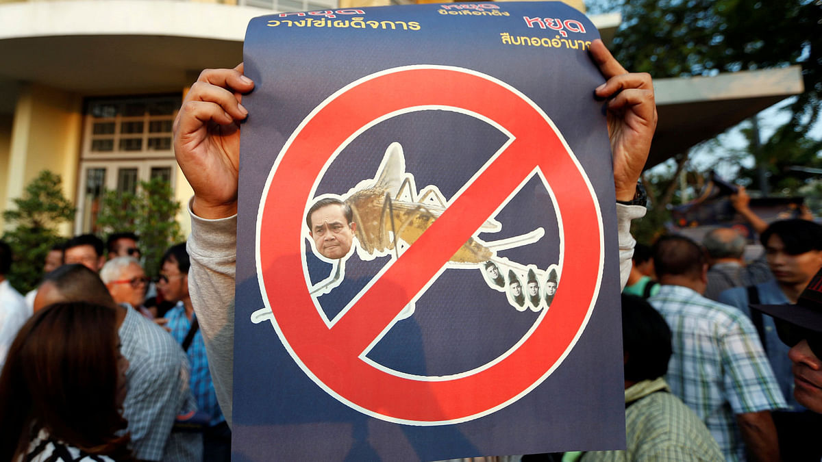 Pro-democracy activists hold up placards during protest against junta near Democracy Monument in Bangkok, Thailand. Photo: Reuters