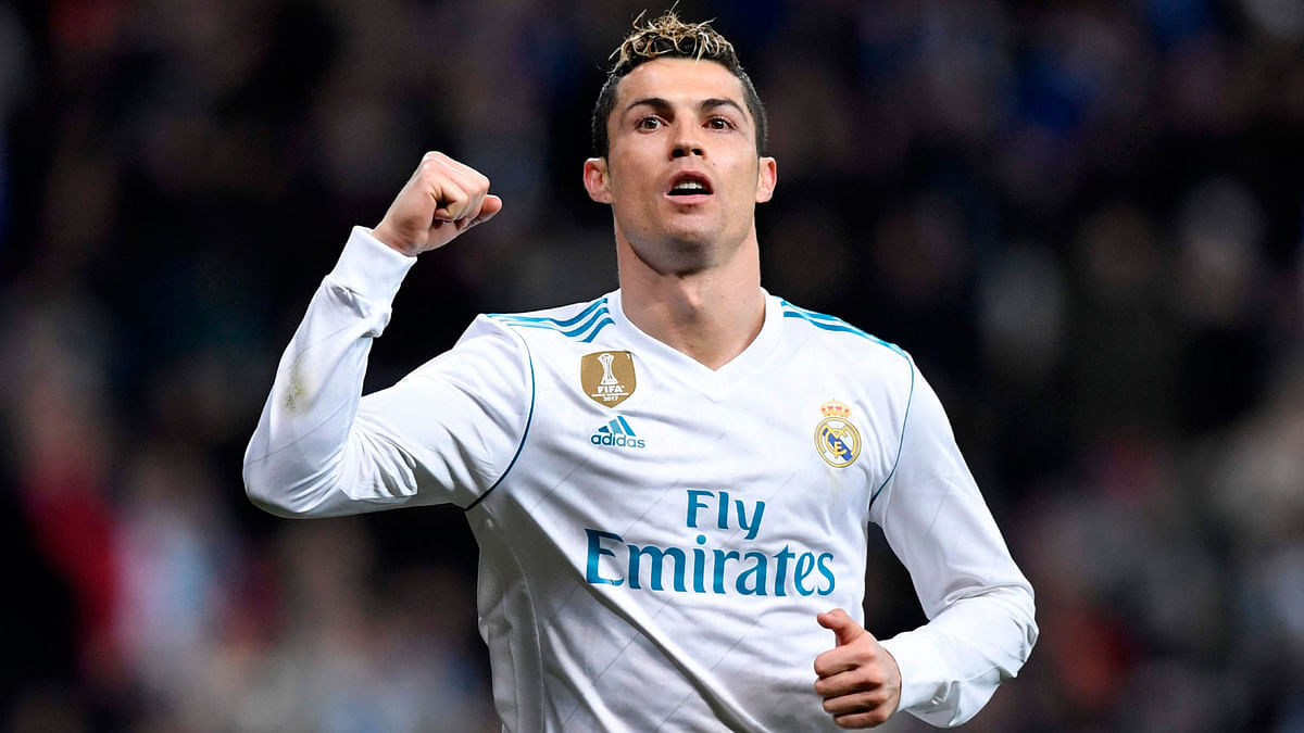 Real Madrid’s Portuguese forward Cristiano Ronaldo celebrates after scoring during the Spanish league football match between Real Madrid CF and Real Sociedad at the Santiago Bernabeu stadium in Madrid on Saturday.