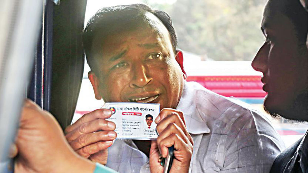 A Dhaka South City Corporation employee pleads to police showing his identity card as the law enforcers arrested him on Saturday along with several others during a BNP demonstration condemning the BNP chief Khaleda Zia’s arrest following her conviction on 8 February. Photo: Sazid Hossain