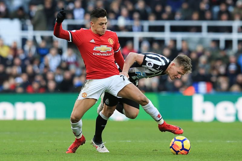 Manchester United`s Chilean striker Alexis Sanchez (L) vies with Newcastle United`s Scottish midfielder Matt Ritchie (R) during the English Premier League football match between Newcastle United and Manchester United at St James` Park in Newcastle-upon-Tyne, north east England on Sunday. Photo: AFP