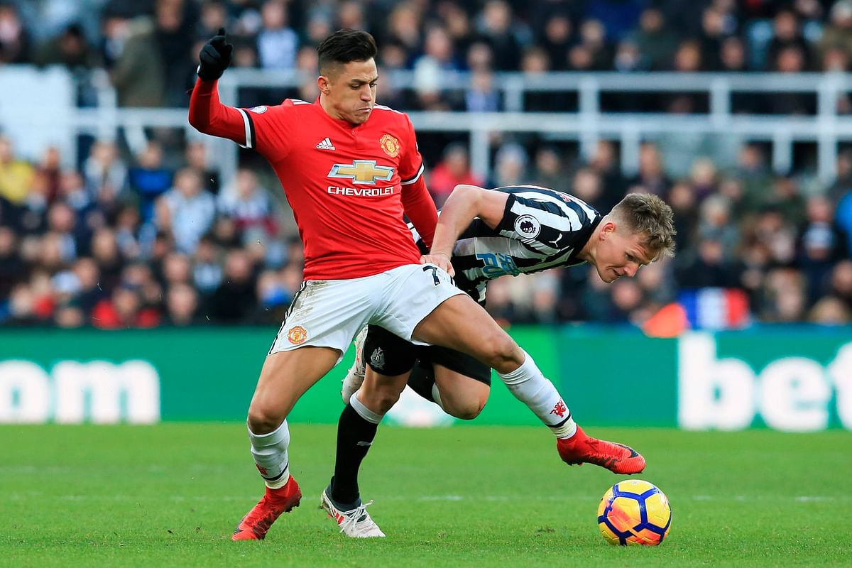 Manchester United`s Chilean striker Alexis Sanchez (L) vies with Newcastle United`s Scottish midfielder Matt Ritchie (R) during the English Premier League football match between Newcastle United and Manchester United at St James` Park in Newcastle-upon-Tyne, north east England on Sunday. Photo: AFP