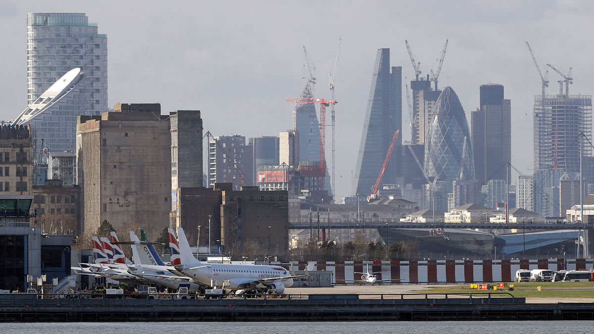Passenger jets stand on the runway of London City Airport, in London. Photo: Reuters
