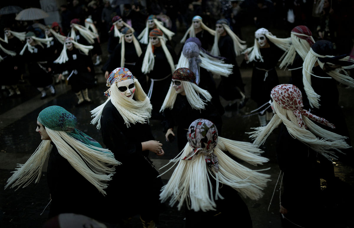 Townswomen dressed as Lamia, with their faces painted white and eyes darkened, sing and dance on Carnival Sunday, in the Basque coastal town of Mundaka, northern Spain on 11 February 2018. Photo: Reuters