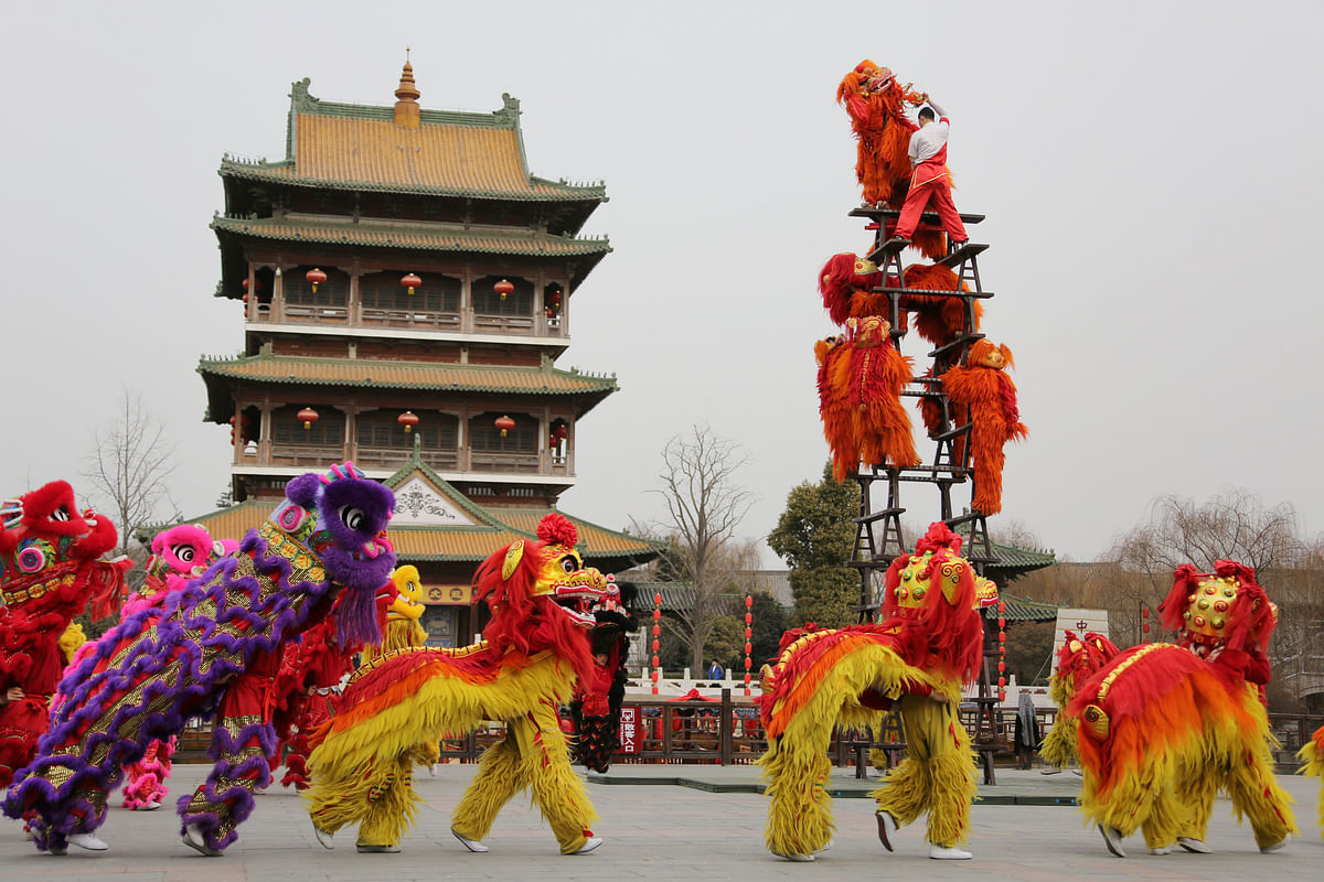 Folk artists perform a lion dance ahead of the Chinese Lunar New Year, or Spring festival, at Taierzhuang Ancient Town scenic area in Zaozhuang, Shandong province, China on 10 February 2018. Photo: Reuters