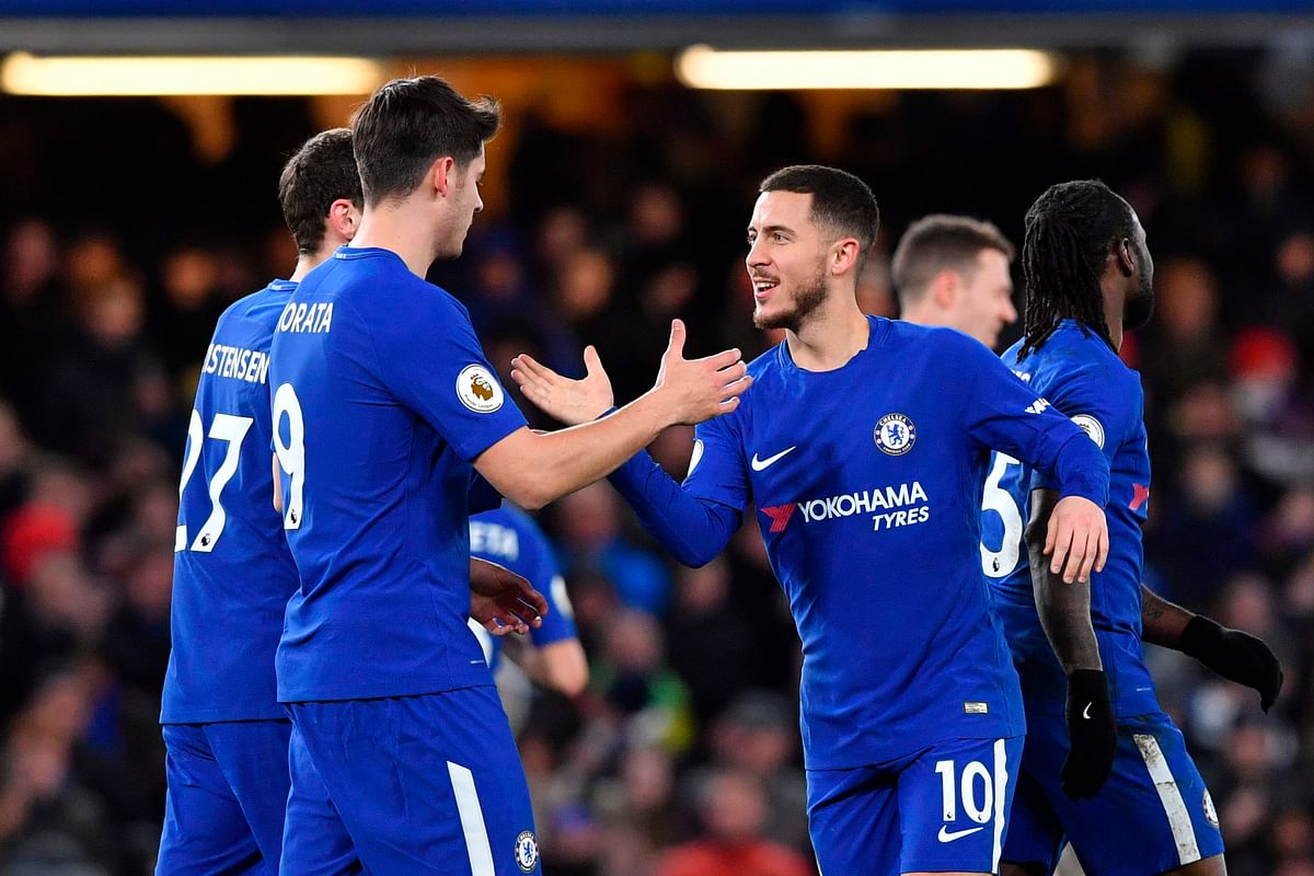 Chelsea’s Belgian midfielder Eden Hazard ® celebrates scoring their third goal during the English Premier League football match between Chelsea and West Bromwich Albion at Stamford Bridge in London on Monday. Photo: AFP