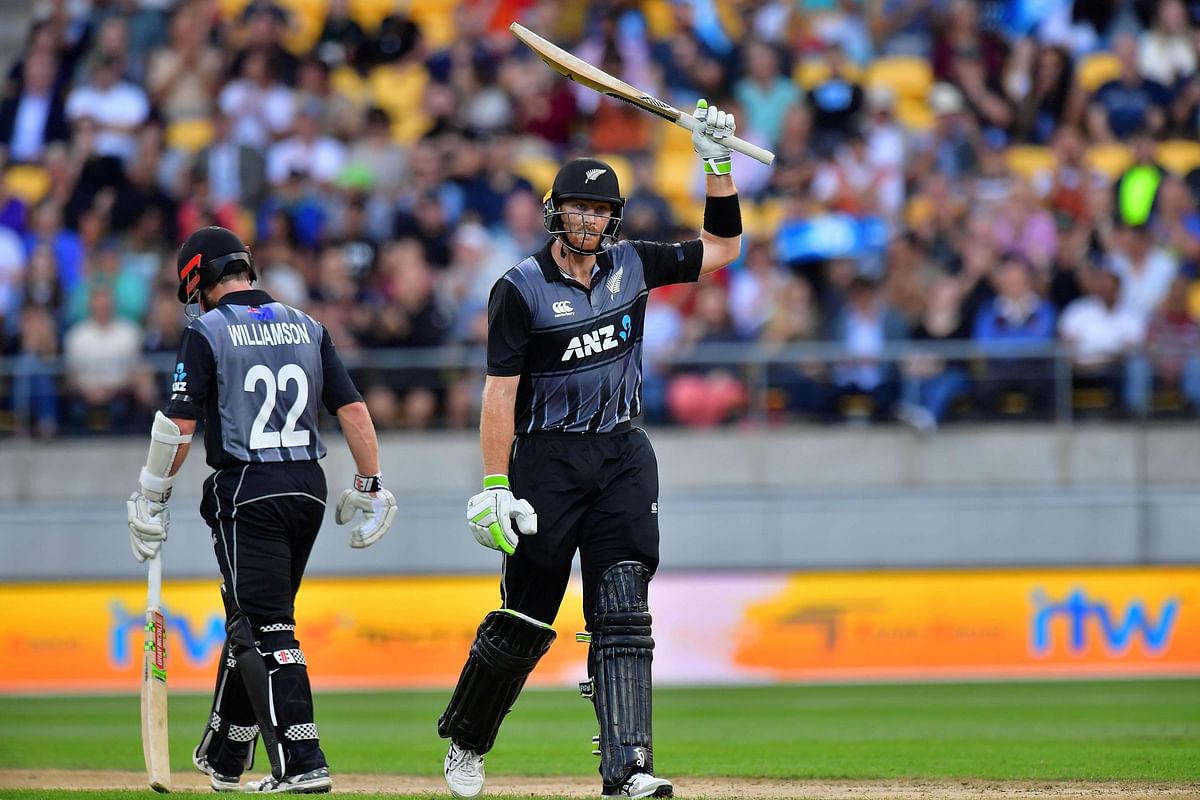 New Zealand's Martin Guptill (R) celebrates reaching his half century with teammate Kane Williamson (L) during the first Twenty20 cricket match between New Zealand and England at Westpac Stadium in Wellington on 13 February 2018. AFP