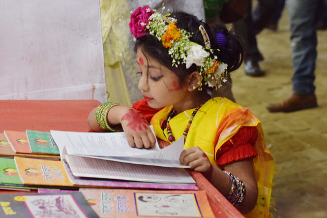 This little girl came to the book fair clad in a saree and a tiara on her head. The photo was taken at the Amar Ekushey Grantha Mela on 13 February 2018. Photo: Quamrul Hassan