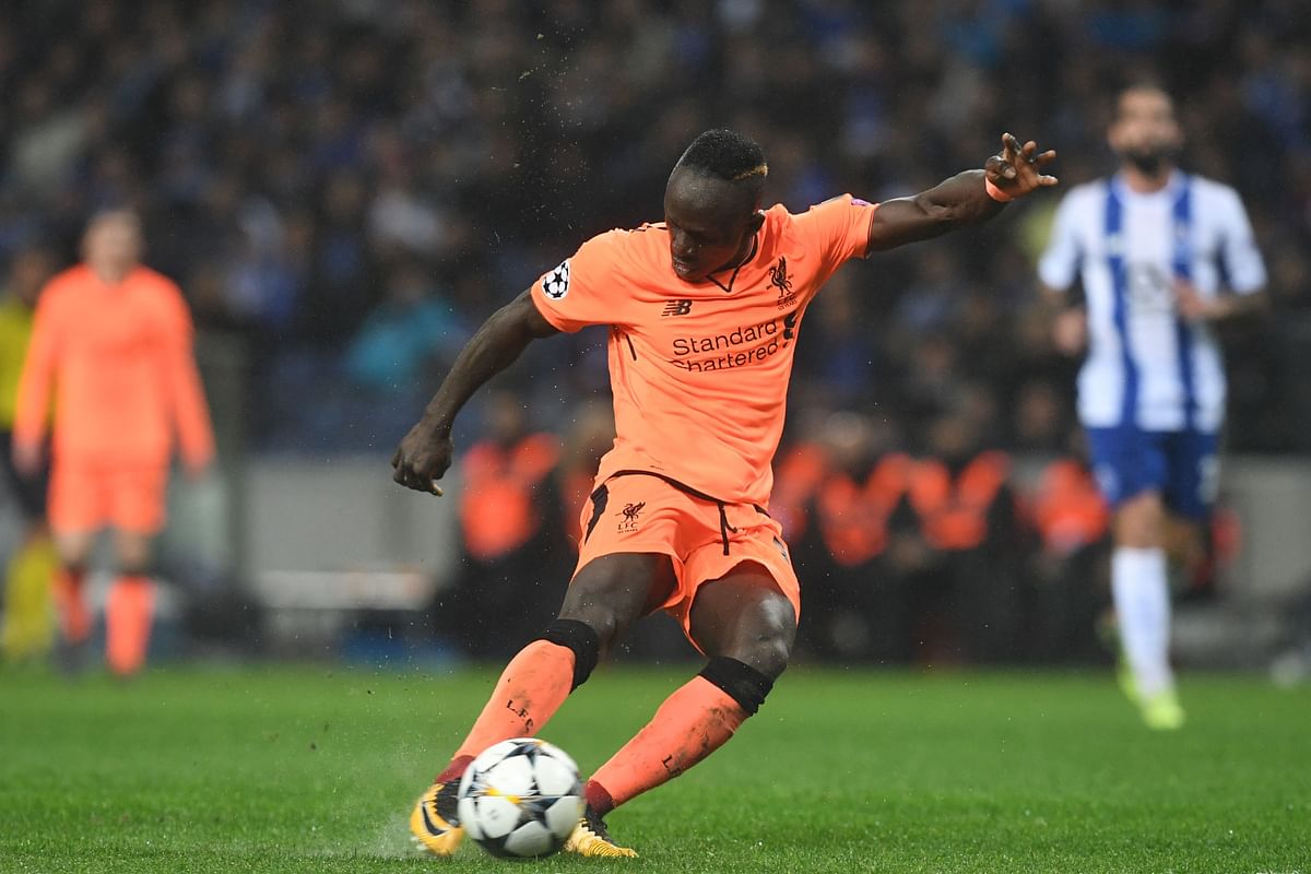 Liverpool’s Senegalese midfielder Sadio Mane shoots to score their fifth goal, his third during the UEFA Champions League round of sixteen first leg football match between FC Porto and Liverpool at the Dragao stadium in Porto, Portugal on Wednesday. Photo: AFP