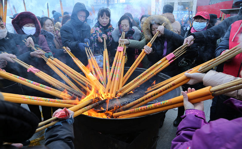 People burn incense sticks and pray for good fortune at the Shisheng Temple on the first day of the Chinese Lunar New Year of Dog, in Shenyang, Liaoning province, China, on 16 February 2018. Reuters