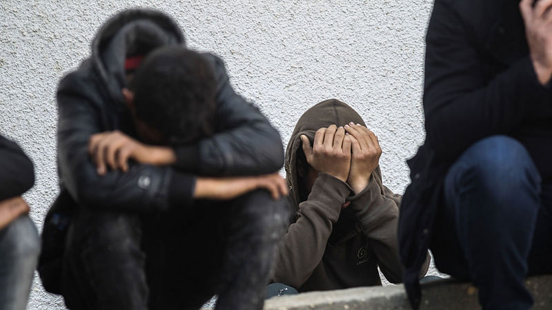 Palestinian relatives of Salam Sabah and Abdullah Abu Sheikha, both 17, mourn during their funeral, in Rafah in the southern Gaza Strip, on 18 February, 2018. Photo: AFP