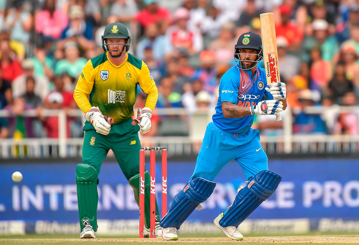 India`s batsman Shikhar Dhawan (R) is watched by South Africa`s wicketkeeper Heinrich Klaasen as he plays a shot during the first T20I cricket match between South Africa and India at The Wanderers Cricket Stadium in Johannesburg on 18 February, 2018. Photo: AFP